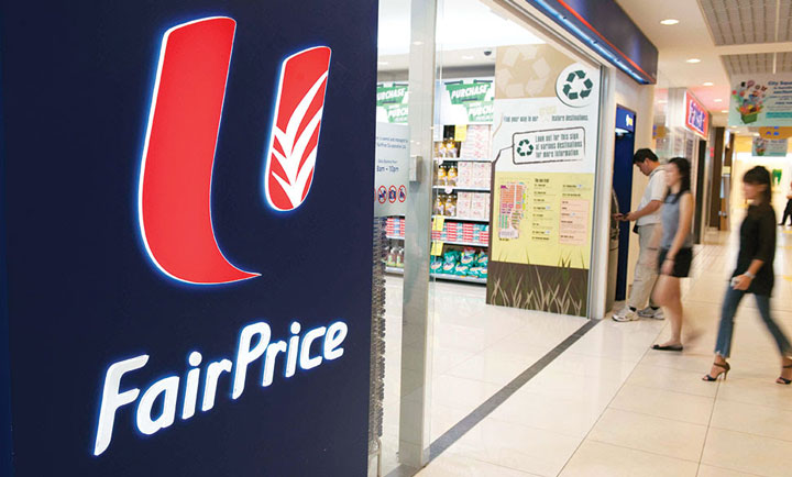Two women walk into a FairPrice Supermarket.