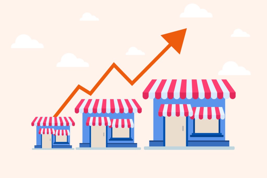 A small business' growth is illustrated by an arrow moving upward over growing shops