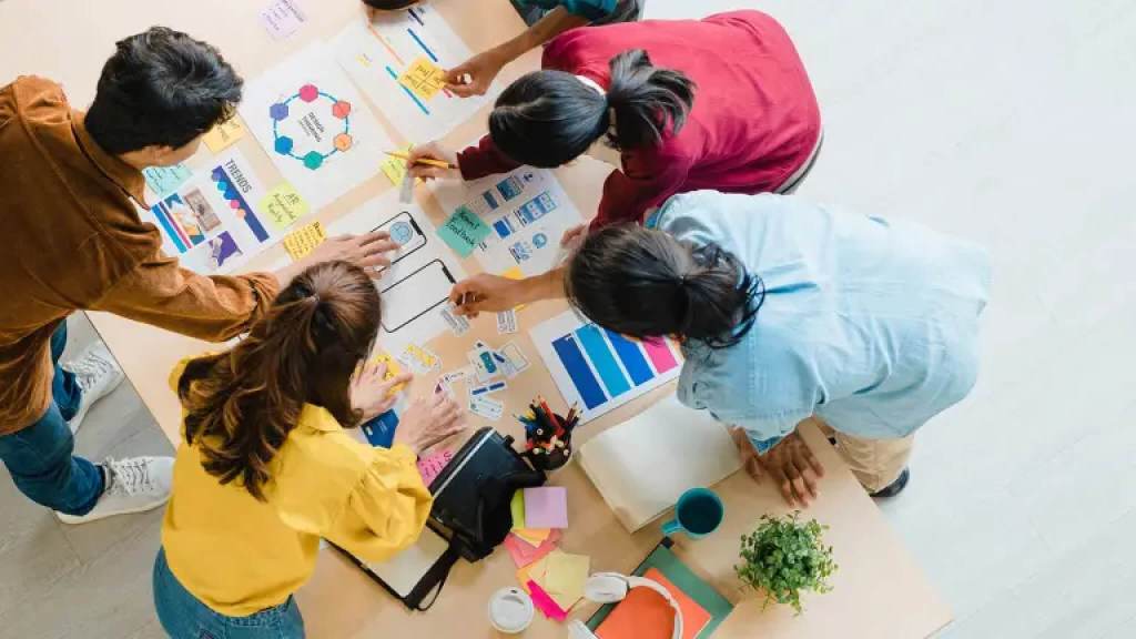 A team maps a user experience on a table.
