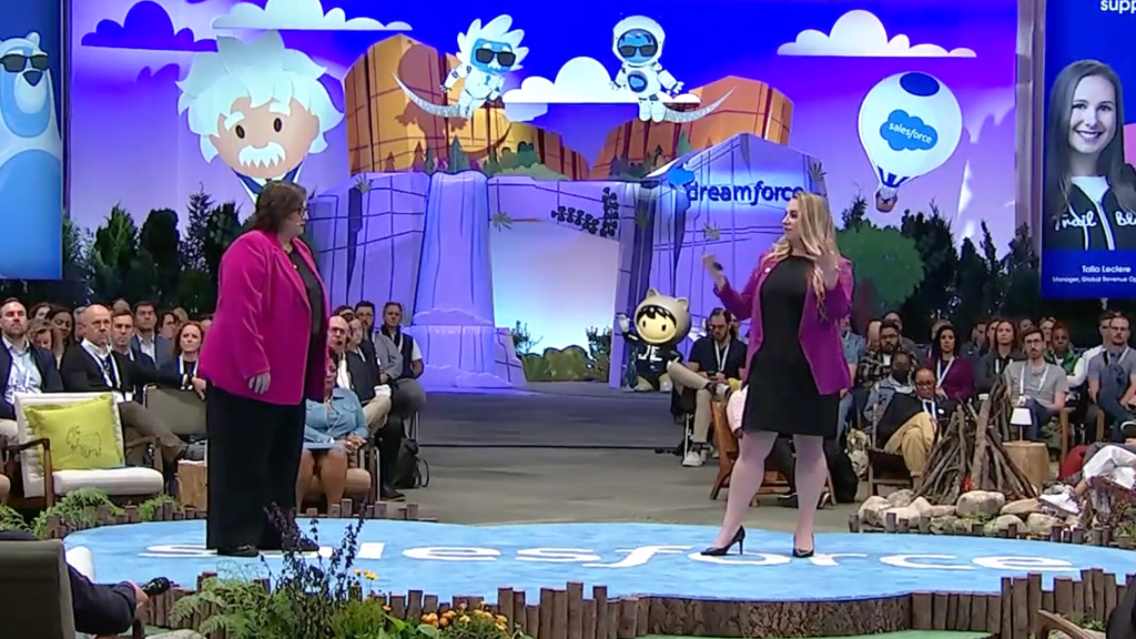 Two people speaking on a stage.